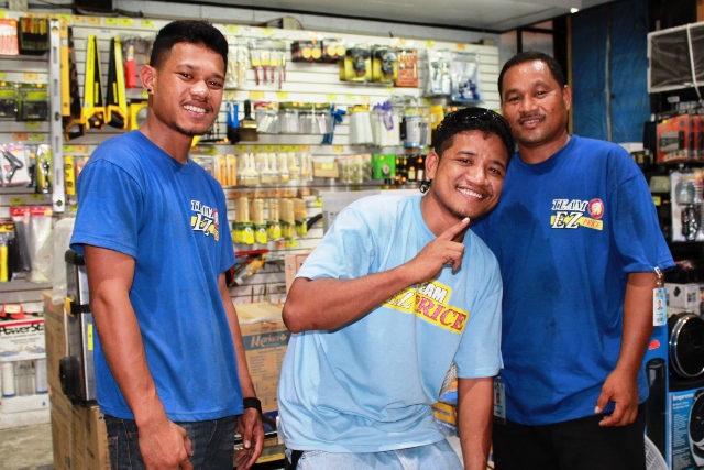 Alumni George Hilai (2013) and Anderson Hampton (2012) with one of their working friend