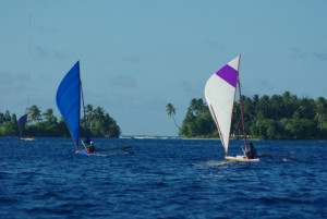 hree canoes race to the rounding mark in the Majuro Day 2015 Canoe Race.