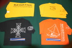 WAM has T-Shirts in three styles. Vertical logo with canoe logo on back (yellow). Stick chart on back (black). Canoe on back (orange).