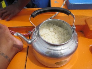 A precious teapot of rice cooked on a burner set under the deck. Photo: WAM