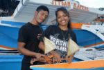 WAM trainees Bilton Ralpho and Naggie Kiluwe with the canoes they made. Photo: Karen Earnshaw