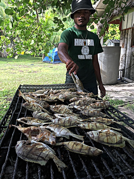 Trainee Scamyo Namdrik cooking fish caught. Photo: Alson Kelen