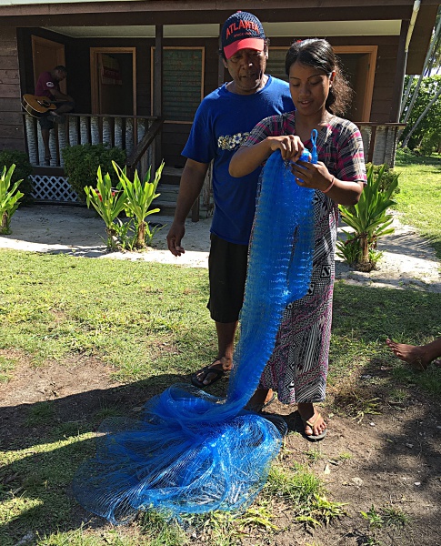 Trainee Roselina Kiluwe learns about net fishing from Trainer Binton Daniel. Photo: Alson Kelen