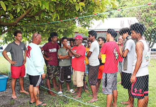 Master Canoe Builder Binton Daniel demonstrating to the trainees how to fix a hole in the fishing net.