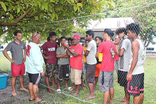 Master Canoe builder Binton Daniel demonstrating how to fix cast net to trainees with Director Kelen. Photo: Sealand Laiden