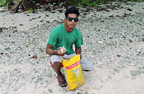Trainee Lajwi Saimon collecting red rock for underground oven Photo: Sealand Laiden